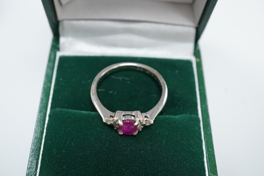 A cased late Victorian 9ct and single stone amethyst set bar brooch, 45mm, a cased yellow metal and single stone white opal set stick pin and a modern 18ct white gold, ruby and diamond cluster ring, size L/M.